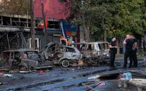 Burnt cars are seen at the site at of a Russian strike at a market in Kostyantynivka, Ukraine's eastern Donetsk region on September 6, 2023, amid the Russian invasion of Ukraine. A Russian strike killed at least 17 people at a market in east Ukraine, officials said, in an attack that President Volodymyr Zelensky described as deliberate and "heinous". (Photo by Polina MELNYK / AFP)