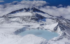 Aerial of a tuquoise crater lake on top of Mount Ruapehu, Tongariro National Park, UNESCO World Heritage Site, North Island, New Zealand, Pacific