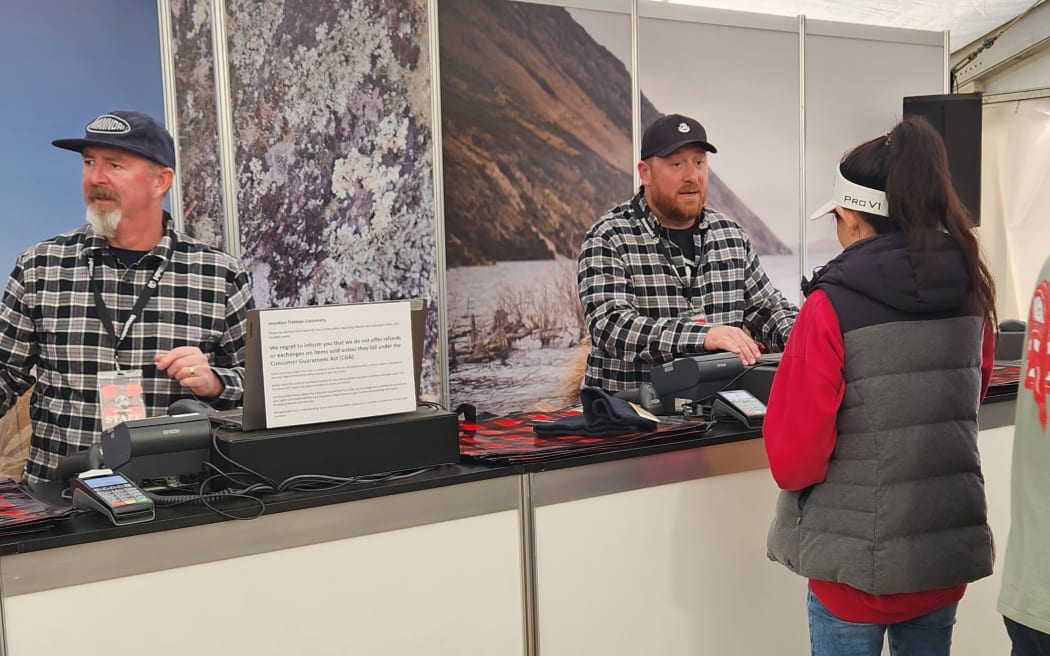 Swanndri tent at Fieldays - head of sales Nic Floyd processing a sale