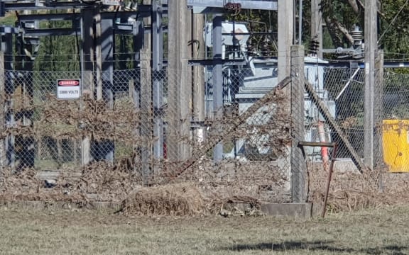 Floodwaters left grass stuck in the Tīnui substation fence. Power is now back on.