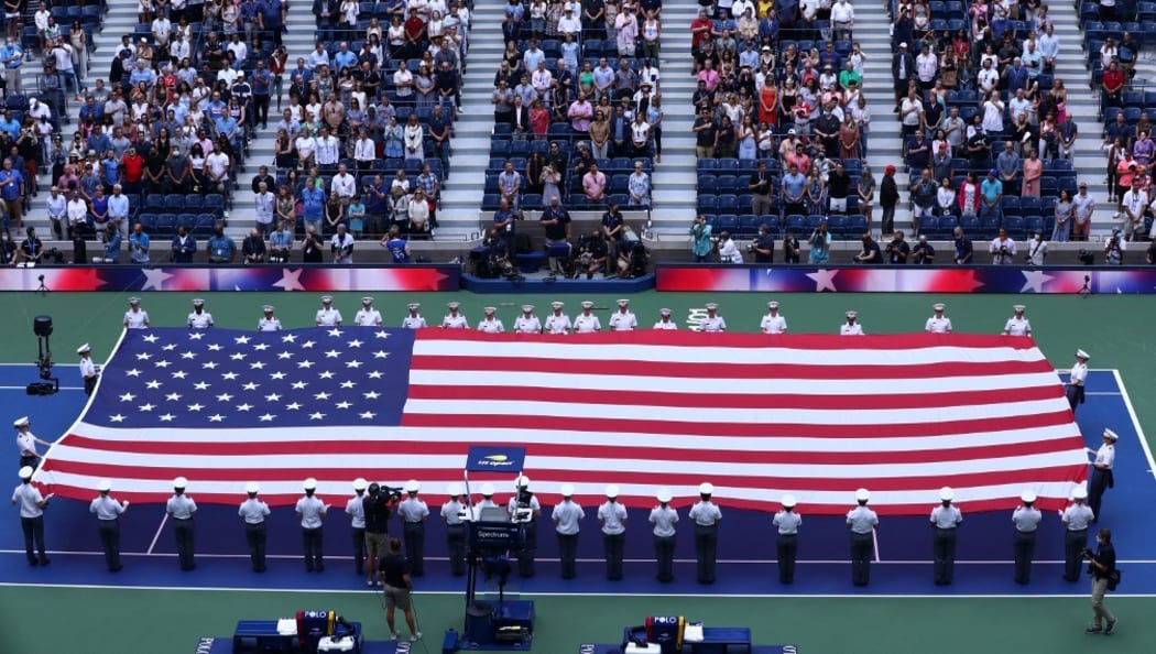 A US flag is held on the court ahead of the 2021 US Open Tennis tournament women's final match at the USTA Billie Jean King National Tennis Center in New York, on September 11, 2021,