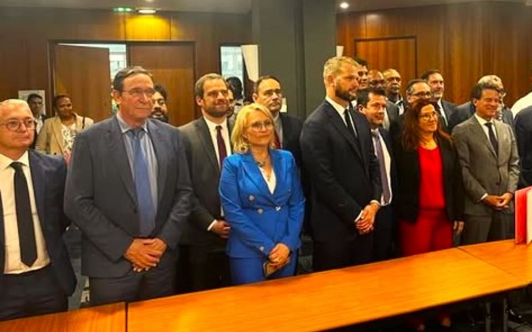 Group photo of participants at the end of negotiations with the signed agreement