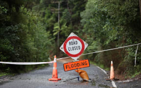 AUCKLAND, NEW ZEALAND - JANUARY 30: Konini Rd in Titirangi is closed with slips and flooding on January 30, 2023 in Auckland, New Zealand. New Zealand's largest city, Auckland, was hit with a historic amount of torrential rainfall on Friday, causing severe flooding which inundated roads and property across the city, with three people so far confirmed dead. Residents and emergency services began to take stock of the damage from the largest amount of rainfall in a day on record, and began recovery efforts over the weekend. (Photo by Fiona Goodall/Getty Images)