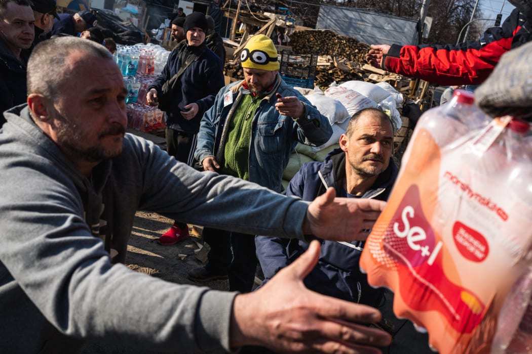 Volunteers cook and distribute food for Kyiv residents and territorial defense in Kyiv, 25 March 2022, as Russian attacks continue.