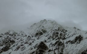 A snowy mountaintop shrouded in mist