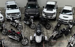 Police seized high-specification Harley Davidson motorcycles, 16 other vehicles and more than $400,000 in cash in raids in Auckland.