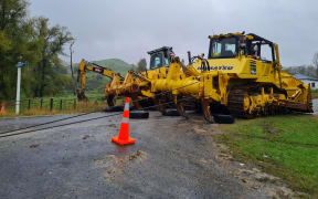Bulldozers reinforce a bridge on Ruakituri Road near the Te Reinga falls on Wednesday 13 April 2022.