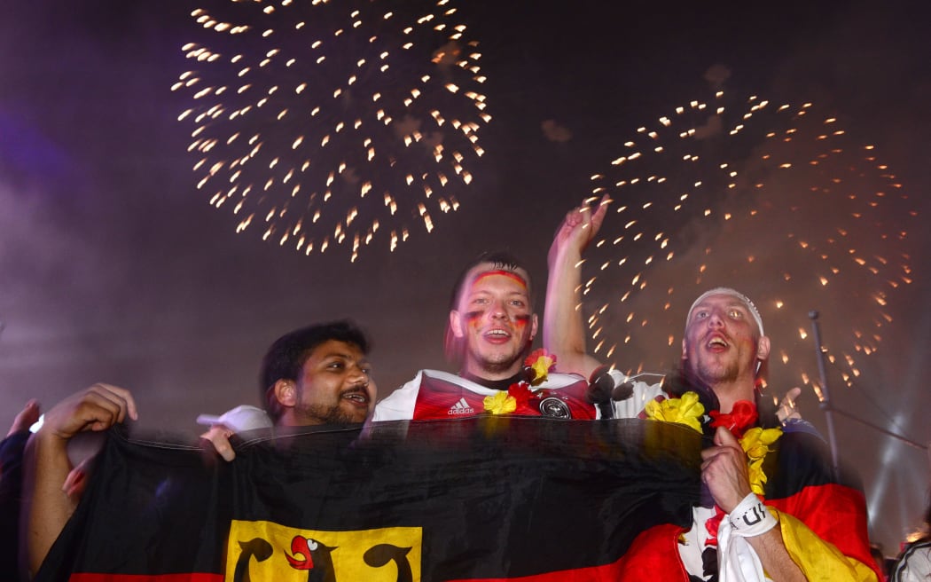 Fans celebrate as fireworks were let off near the Brandenburg Gate in Berlin.