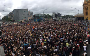 A crowd gathers outside Melbourne's Flinders Station to protest the date of Australia Day.