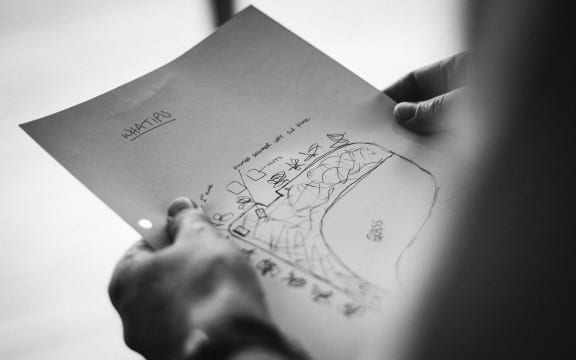McKinnel holds a map of the car park at Whatipu. Deane Fuller-Sandys was presumed drowned for years before police decided to open a murder investigation.