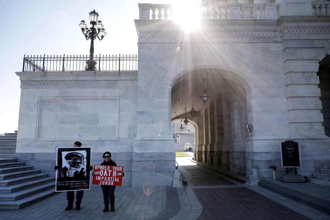 Demonstrators stand outside the U.S. Capitol as the impeachment trial of President Donald Trump begins in the U.S. Senate January 16, 2020 in Washington, DC.