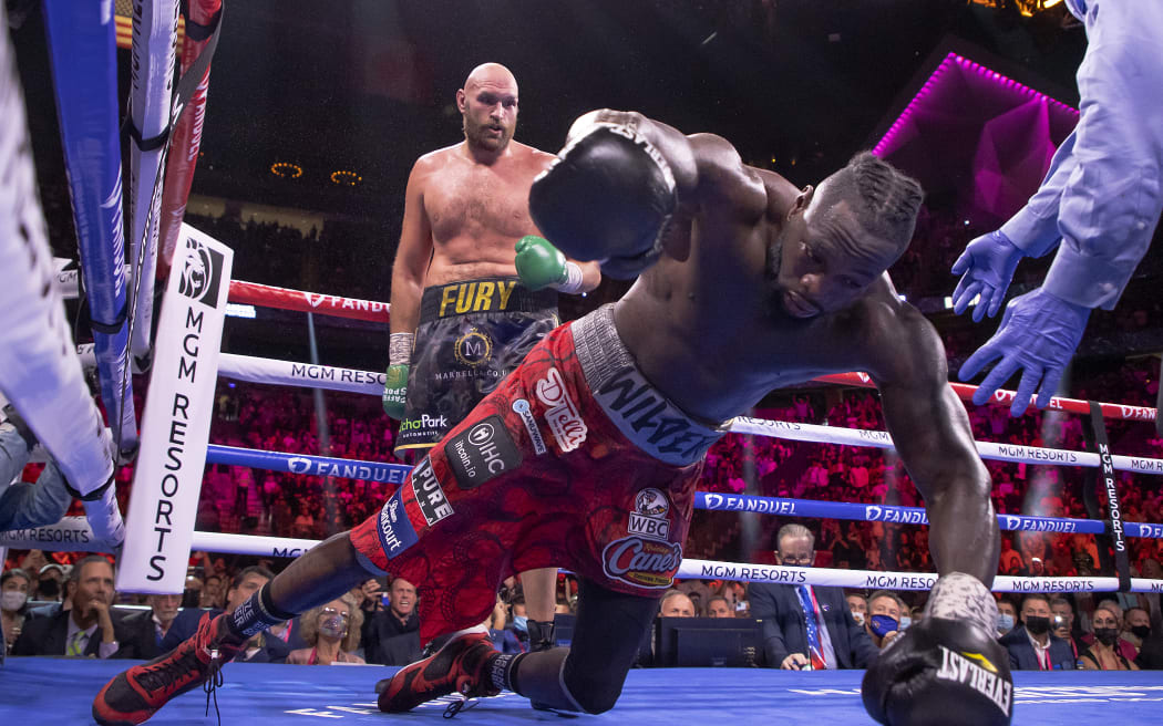 Deontay Wilder (R) is knocked out by Tyson Fury in the 11th round during their WBC heavyweight title fight at T-Mobile Arena on October 09, 2021 in Las Vegas, Nevada.