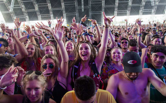 (FILES) In this file photo taken on April 15, 2018 fans cheer as Petit Biscuit performs at the Coachella Music and Arts Festival in Indio, California, -