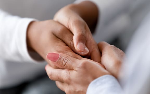Close up caring African American mother holding child hands, showing love and support, black mum comforting, caressing kid, children protection concept, family enjoying moment together