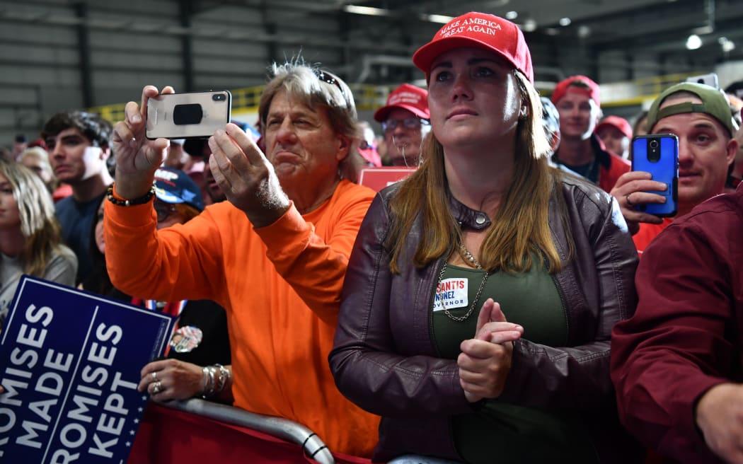 Supporters of US President Donald Trump listen while he speaks during the campaign rally in Pensacola.
