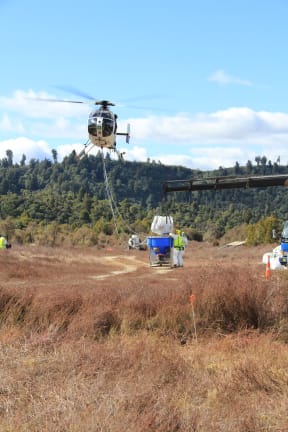 A bait bucket being refilled during an aerial 1080 operation in the Tongariro Conservation Area