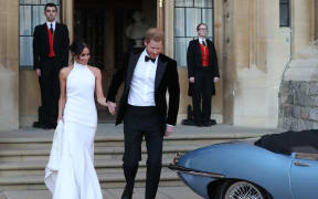 Britain's Prince Harry, Duke of Sussex, (R) and Meghan Markle, Duchess of Sussex, (L) leave Windsor Castle