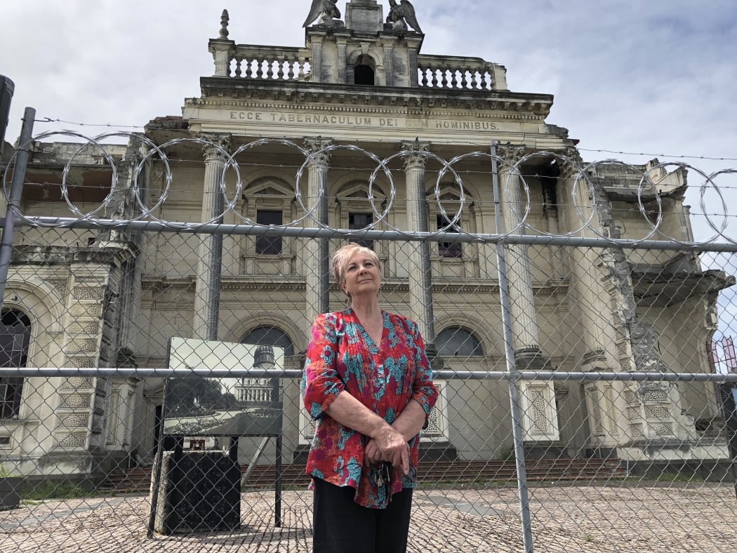 Anna Crighton, chair of Christchurch Heritage Trust,  in front of Christchurch's earthquake damaged Catholic Cathedral of the Blessed Sacrament