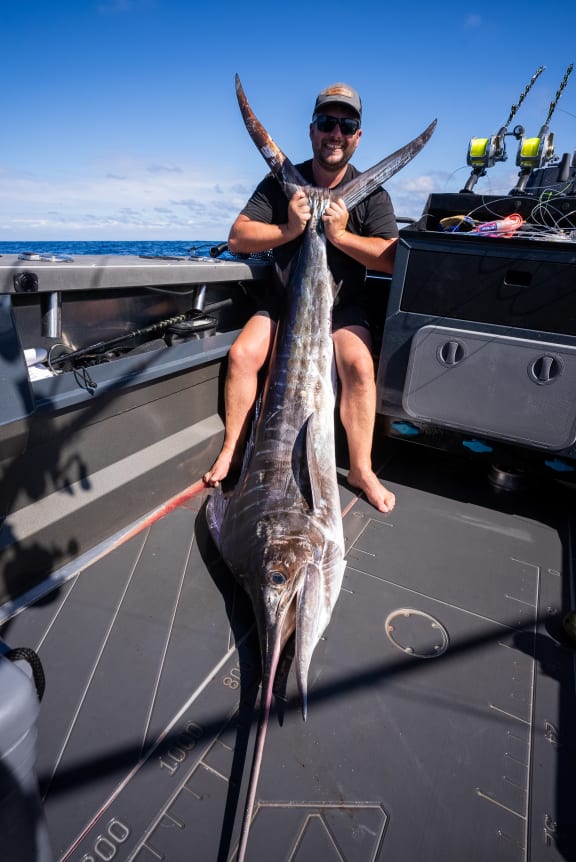 Jason Anderson with a striped marlin he caught off the West Coast of the South Island.