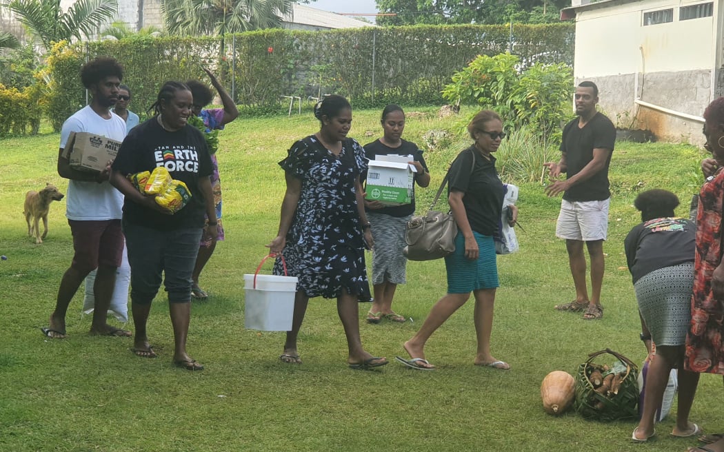 Church members help stranded Solomon Islands nurses in Vanuatu by taking food and other supplies.