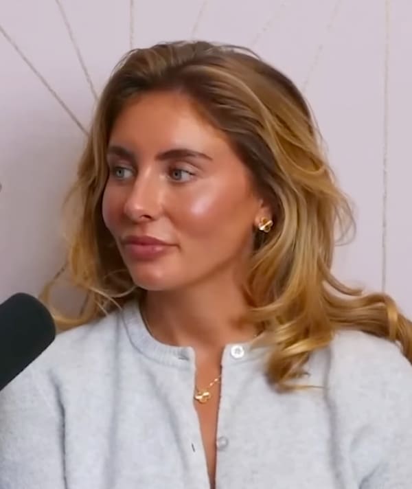 Bonnie Blue is a heavily made up, blonde-haired woman with a microphone near her face.