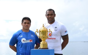 Samoa captain David Lemi and Fiji's Akapusi Qera pose with the Webb Ellis Cup ahead of Saturday's Pacific Nations Cup decider, which doubles as a World Cup qualifier.