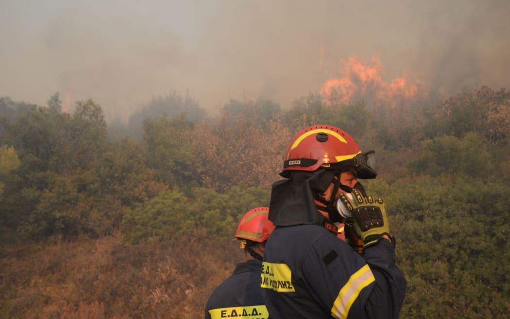 Firefighters are operating during a wildfire in Varnavas, north of Athens, on August 12, 2024. Greece is battling several wildfires on August 11, with smoke covering parts of the capital Athens in a haze, amid warnings for extreme weather conditions for the rest of the week. (Photo by Dimitris Lampropoulos/NurPhoto) (Photo by Dimitris Lampropoulos / NurPhoto / NurPhoto via AFP)