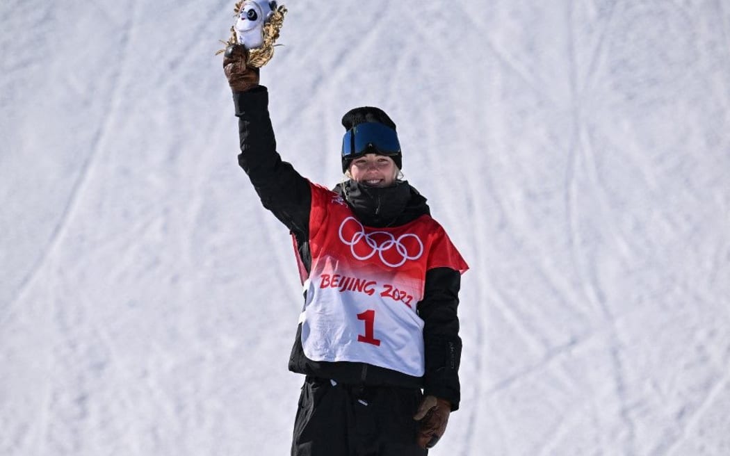 Gold medallist New Zealand's Zoi Sadowski Synnott poses on the podium during the medals ceremony after the snowboard women's slopestyle final run at the Genting Snow Park H & S Stadium in Zhangjiakou on February 6, 2022.