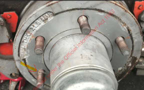 An arrow on a photo of a dental clinic trailer wheel shows where a wheel stud is close to being shorn through. Source: OIA from Waka Kotahi to RNZ