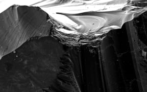 An ultra-high-resolution image of a obsidian shard, magnified up to 800,000 times.