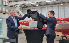 Life Flight chief executive Mark Johnston and Health Minister Simeon Brown officially open the new aeromedical airbase for the upper north island at Hamilton airport.