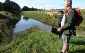The Waima river once flowed into the left hand channel and around a U-shape bend. Now most of the water flows into the channel on the right, dug to move floodwaters more speedily off surrounding farmland.