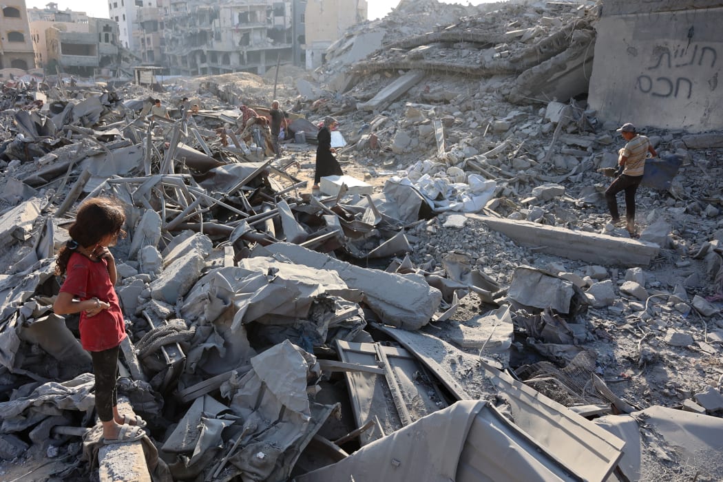 Palestinians inspect the damage after an overnight strike on the Sheikh Radwan Health Centre run by the United Nations Relief and Works Agency for Palestine Refugees (UNRWA) in the north of Gaza City on August 6, 2025. Gaza's civil defence agency said 68 people were killed by Israeli gunfire and air strikes on August 5, including 56 who were waiting near aid distribution sites inside the Palestinian territory.