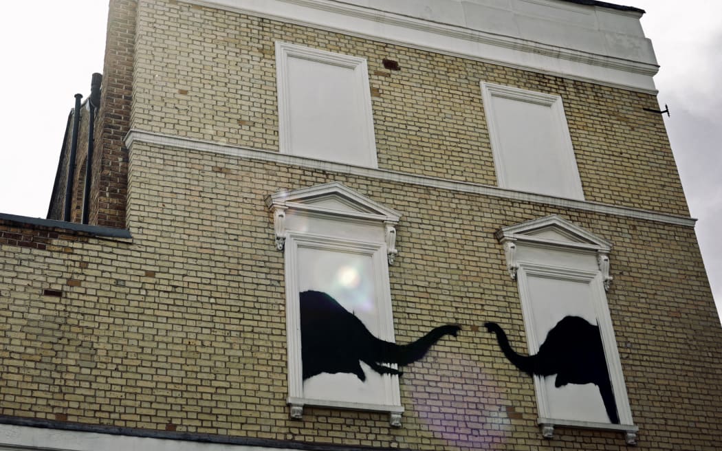 A photograph taken on August 6, 2024, shows a Banksy artwork, depicting elephants, painted on the side of a building in west London. The Artist confirmed the work to be theirs after posting an image of it on the social media app Instagram. (Photo by BENJAMIN CREMEL / AFP) / RESTRICTED TO EDITORIAL USE - MANDATORY MENTION OF THE ARTIST UPON PUBLICATION - TO ILLUSTRATE THE EVENT AS SPECIFIED IN THE CAPTION