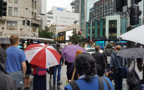 A sea of umbrellas as rain falls in the Auckland CBD