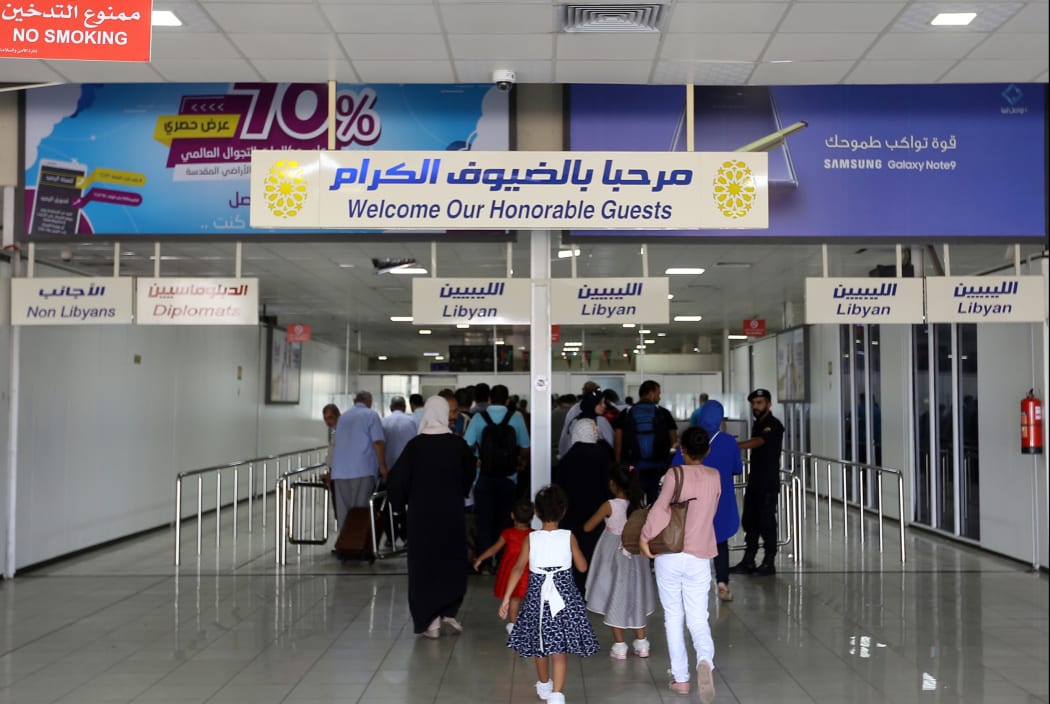Travellers arrive at the Mitiga International Airport after its reopening on September 7, 2018, in the Libyan capital of Tripoli.