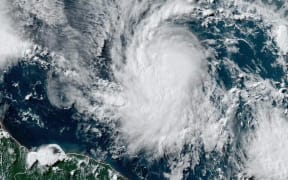 This National Oceanic and Atmospheric Administration (NOAA)/GOES satellite handout image shows Tropical Storm Beryl at 19:30UTC on June 29, 2024. Much of the southeast Caribbean went on alert Saturday as Tropical Storm Beryl was set to undergo rapid strengthening, becoming a "dangerous" major hurricane before it crosses the Windward Islands sometimes on June 30, forecasters said.
Barbados, St Lucia, St Vincent and the Grenadines and Grenada all had hurricane watches in place, the US National Hurricane Center said, as Beryl swirled in the Atlantic. (Photo by HANDOUT / NOAA/GOES / AFP) / RESTRICTED TO EDITORIAL USE - MANDATORY CREDIT "AFP PHOTO /NOAA/GOES" - NO MARKETING NO ADVERTISING CAMPAIGNS - DISTRIBUTED AS A SERVICE TO CLIENTS