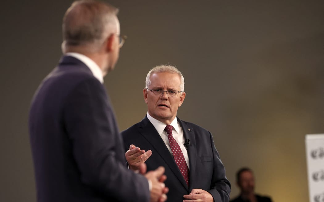 Australian Prime Minister Scott Morrison (right) and leader of the opposition, Anthony Albanese, participate in the first leaders' debate of the 2022 federal election campaign at the Gabba in Brisbane on April 20, 2022.