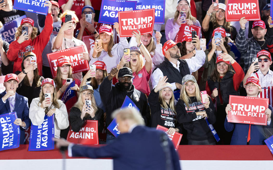 Supporters cheer as former US President and Republican presidential candidate Donald Trump speaks during a campaign rally at the J.S. Dorton Arena in Raleigh, North Carolina on November 4, 2024.