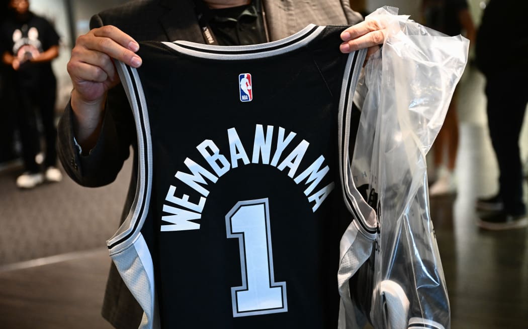 A fan displays a French basketball player Victor Wembanyama jersey after his selection for the  San Antonio Spurs.