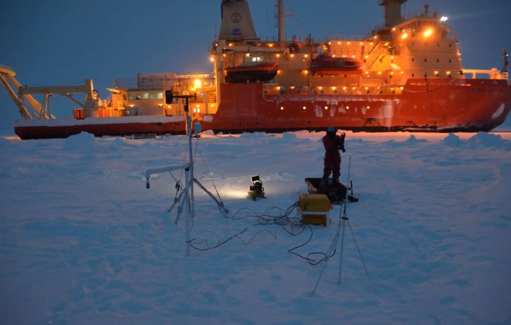 Nathaniel B Palmer can be seen in the background while researchers work during the expedition.