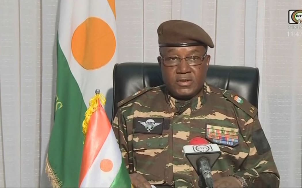 This video frame grab image obtained by AFP from ORTN - Télé Sahel on 28 July, 2023 shows General Abdourahamane Tchiani speaking on national television and reads a statement as "President of the National Council for the Safeguarding of the Fatherland", after the ousting of President-elect Mohamed Bazoum. The chief of the Presidential Guard justifies the coup by evoking "the continued deterioration of the security situation" in the country, as well as "poor economic and social governance". (Photo by ORTN - Télé Sahel / AFP)