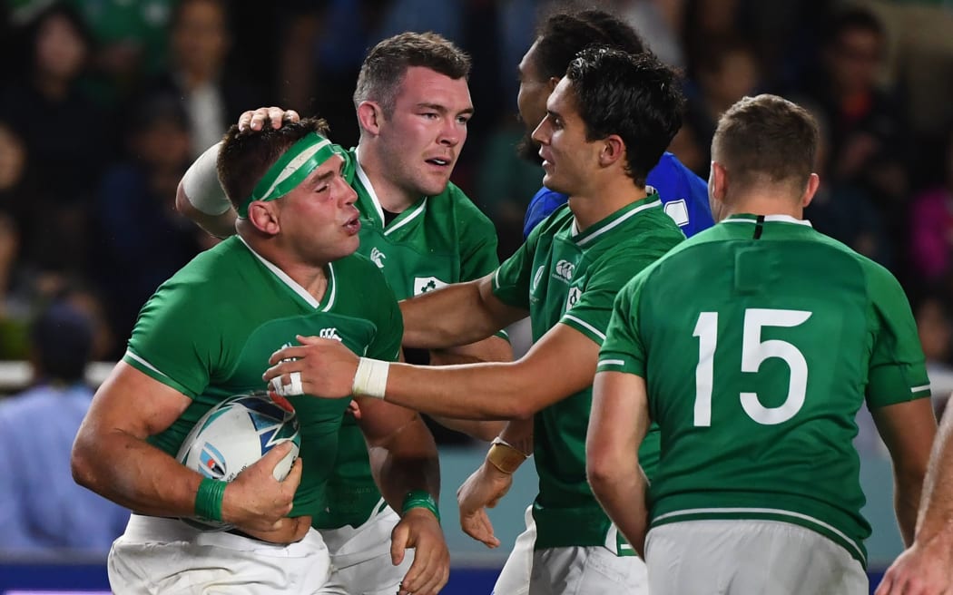 Ireland's number 8 CJ Stander (L) reacts after scoring a try  during the Japan 2019 Rugby World Cup Pool A match between Ireland and Samoa