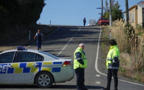 A section of Coast Road is closed after a woman was found dead inside a property.