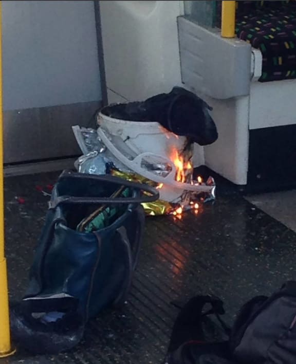 An image from social media shows a white container burning inside a London Underground tube carriage.