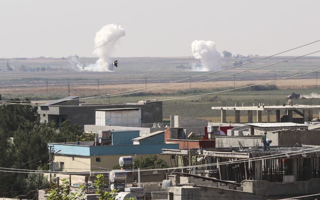SANLIURFA, TURKEY - OCTOBER 10: Smoke rises after howitzers of Turkish Armed Forces hit terror targets in Tell Abyad  in northern Syria, against PKK/YPG, Daesh terrorists, on October 10, 2019 in Sanliurfa, Turkey.