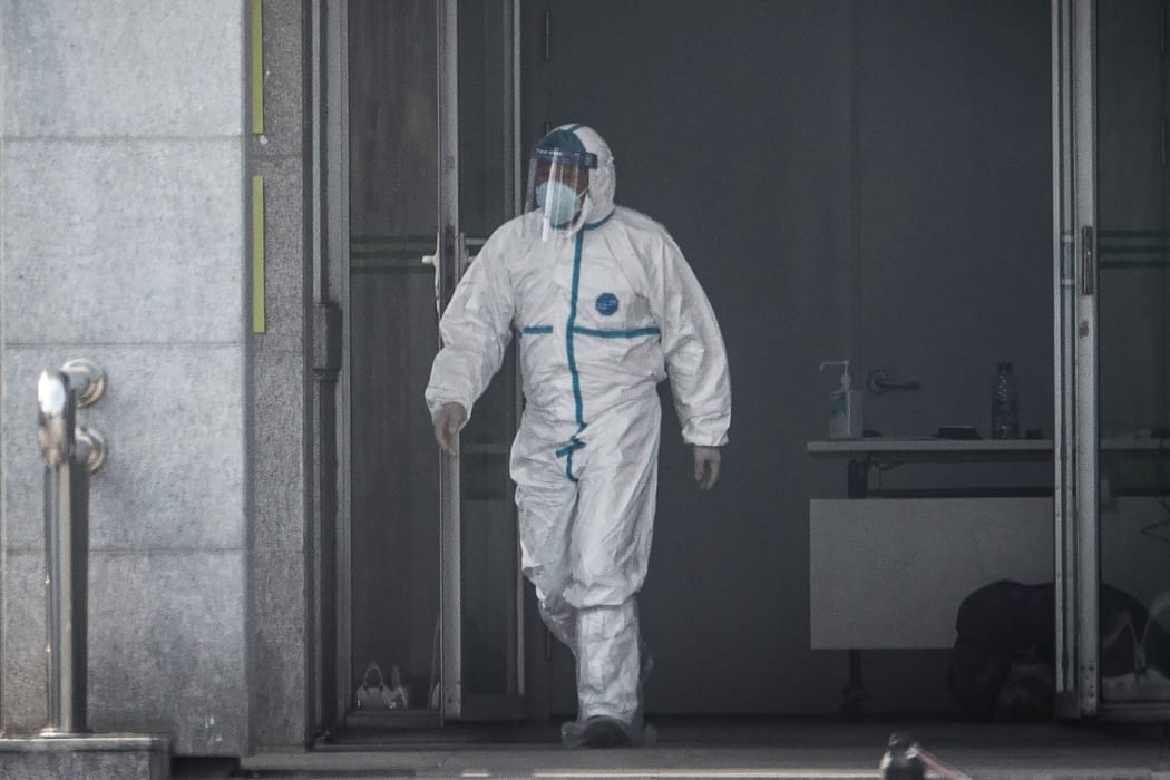 A medical staff member walks outside the Jinyintan hospital, where patients infected by a mysterious SARS-like virus are being treated (January 18, 2020).