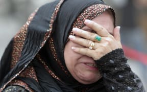An Iraqi woman whose flat was destroyed in a massive bombing in Baghdad's Karrada neighbourhood reacts as she visits the aftermath of the attack.