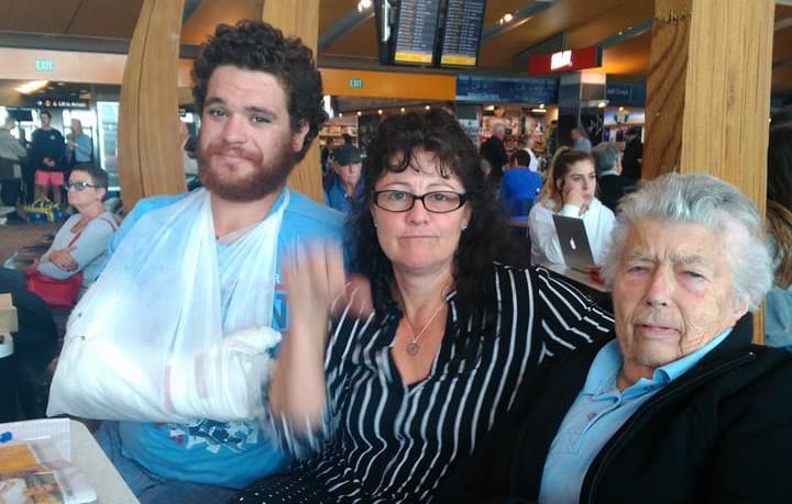 Stranded passenger Vickie Davis, centre, with fellow Air New Zealand passengers initially offered only a pillow and blanket. Named on social media as Augustus Whanga, left, and Gillian Finnegan, 84, right.