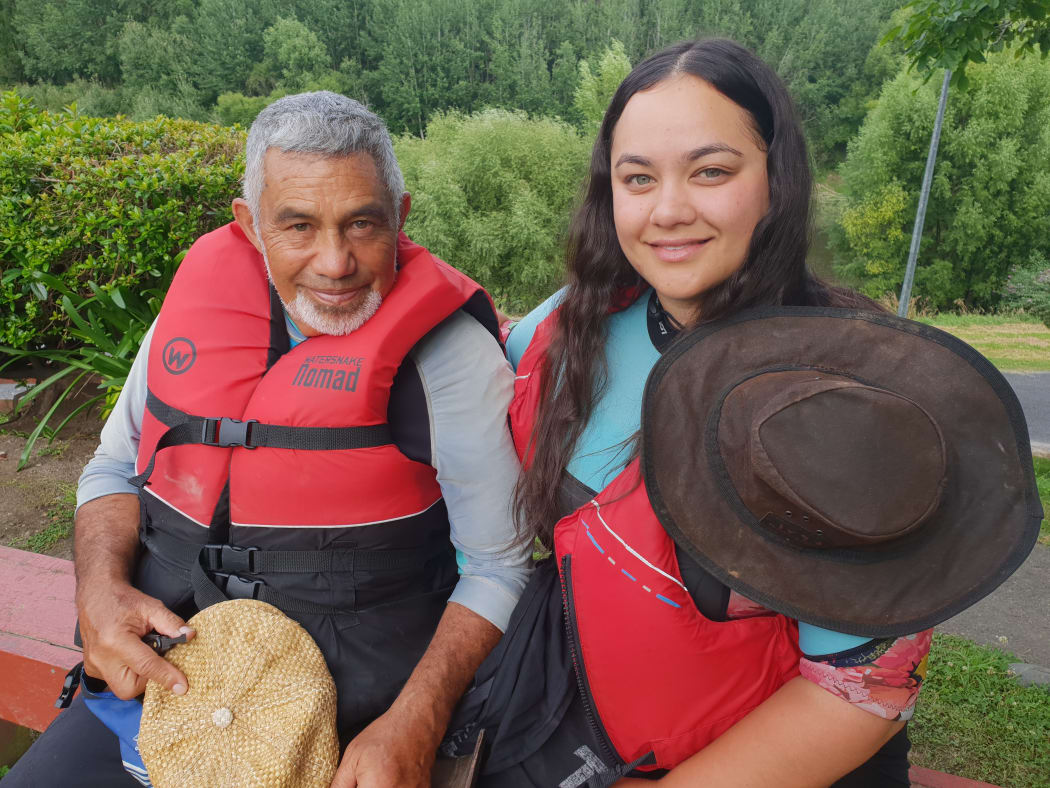 Leah Te Whata, with her Papa, during the annual Tira Hoe Waka Whanganui River pilgrimage, January 2019.